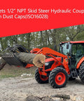 Side view of orange skid-steer loader with metal log grapple lifting a tree trunk outdoors