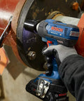 Worker using 18V EC Brushless Half Inch Impact Wrench with Friction Ring and Through Hole Bare Tool on metal pipe flange