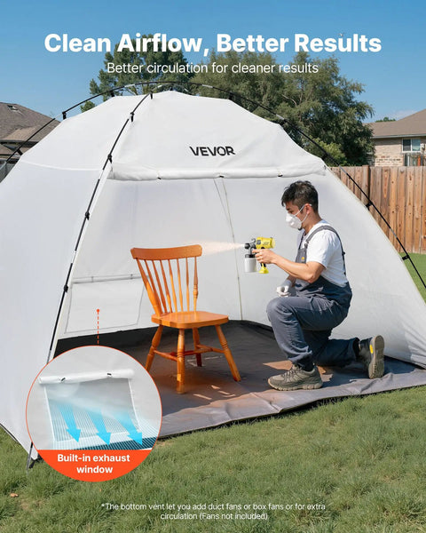 Man using spray gun in Portable Paint Booth Tent with Built In Floor And Mesh Screen Huge 115.35 By 90.55 By 74 Inch Spray Shelter