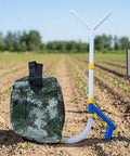 Backpack Manual Spreader Dispenser For Farming 20L Capacity With Bag in field, PVC construction for spreading manure or fertilizer.