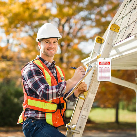 60 Pack Ladder Inspection Tags With Double Sided Safety Record Labels And Beefy Nylon Cords Plus Durable Ink Pen For Warehouse Crews And Municipal Sites Easy Grip Layout Straight Talk Compliance Notes Built Tough For The Day Shift Grind used by a worker inspecting a ladder.