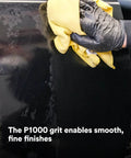 Person using a cloth on an auto body panel to finish sanding, highlighting P1000 grit for smoothing Trizact Hookit 3 Inch Blending Disc action.