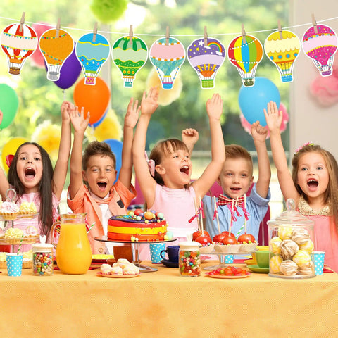 Birthday party scene with colorful hot air balloon cutouts set for classroom decor 36 pieces in 9 designs with glue dots.