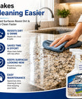 Person cleaning granite countertop with hassle free spray sealant that locks down granite and marble countertops against daily messes.