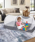 Indoor view of a child playing inside a Large Pop Up Bed Mosquito Net Canopy For Bed Camping And Travel Portable Travel Friendly Foldable Tent.
