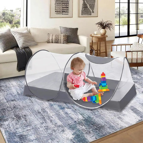 Indoor view of a child playing inside a Large Pop Up Bed Mosquito Net Canopy For Bed Camping And Travel Portable Travel Friendly Foldable Tent.