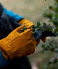 Durable Synthetic Leather Kids Garden Gloves For 7 To 9 Year Olds in use, bright yellow, non-slip, with plant in hand
