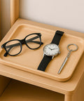 Compact 4 Piece Mini Eyeglass Screwdriver Set With 3 In 1 Flathead And Phillips Drivers on a wooden tray with glasses and watch.