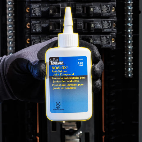 Noalox Anti Oxidant Compound For Aluminum Conduit Joints Reduces Galling And Seizing With Zinc Particles 4 oz bottle in hand