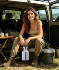 Woman outdoors with 2L Stainless Steel Travel Cup With Handle Wide Mouth Water Bottle For Hiking Fishing And Outdoor Sports Built To Last