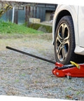 3 Ton Floor Jack Handle Replacement For Automotive Jacks That Fits Pittsburgh Floor Jack Parts And Other Horizontal Hydraulic Car Jacks For Easy Lifts And Smooth No Hassle Operation In Home Or Shop in use lifting car wheel in outdoor setting