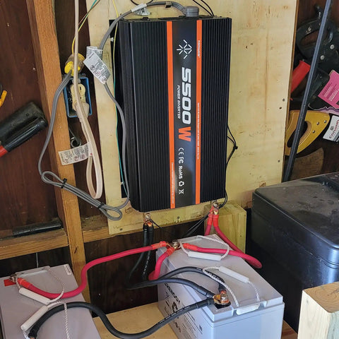 Heavy Duty 5500W Power Inverter 12V to 110V Converter With LCD Display mounted with battery connections for RV or camping.