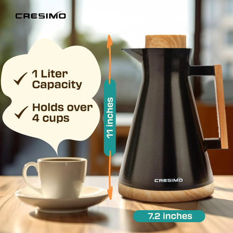 Vacuum Insulated Thermal Carafe 34 Oz Keeps Coffee Hot for 12 Hours with Glass Wall and Beech Wood Accents next to a cup