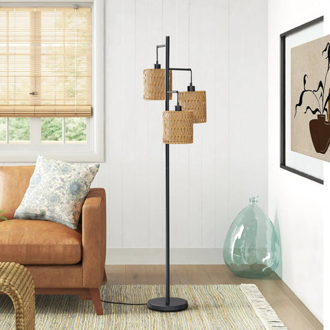 65 Inch Boho Rattan Floor Lamp With Three Lights next to a couch in a living room, featuring rattan shades and metal frame.
