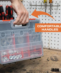 Person holding plastic tool organizer with clear lid and comfortable handles, displaying hardware compartments on workbench.