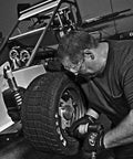 Mechanic using Heavy-Duty 1/2 Inch Composite Air Impact Wrench With Twin-Hammer Power on race car wheel