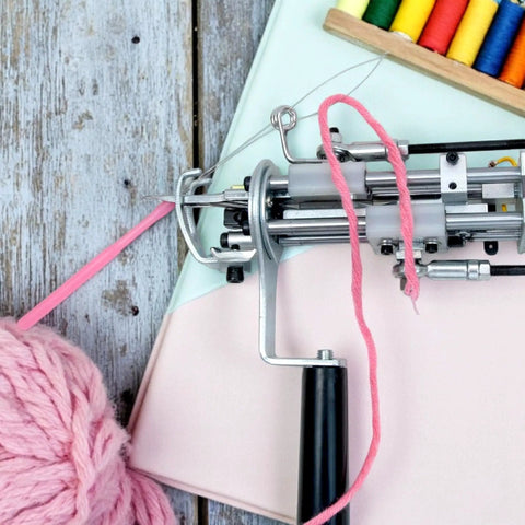 5 Pack Needle Threaders For Hand Sewing And Machine Threading Plastic Threader Tools visible with pink yarn in sewing machine setup.