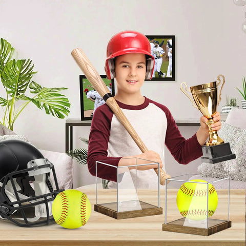 Child holding trophy behind Clear Acrylic Softball Display Case With Wood Base For One Ball, Dustproof Memorabilia Stand Cube Holder.