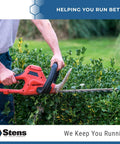 Red electric hedge trimmer cutting a dense green hedge; Stens logo visible.