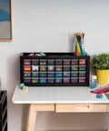 Heavy Duty 32 Drawer Tool Organizer And Hardware Storage Cabinet For Nuts Bolts And Small Parts With Slick Compact Footprint Rock Solid Design Big Time Garage Essential For Desktop Workbench In Black on a workspace.