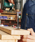Person using drill with Eight Piece Wood Drill Bits Set Carbon Steel Brad Point Kit For Woodworking on wooden planks