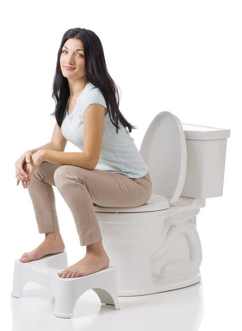 Woman demonstrating Original Bathroom Toilet Stool Set With 7 And 9 Inch Heights In White Doctor Recommended, seated on toilet