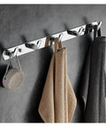 Heavy Duty Chrome Wall Hook Handles Daily Hustle In Bathrooms And Kitchens While Snagging Towels Keys And Coats To Stay Put On Tile Or Drywall Locks Down Solid With Zero Rust After Quick Install holding towels on a gray wall.