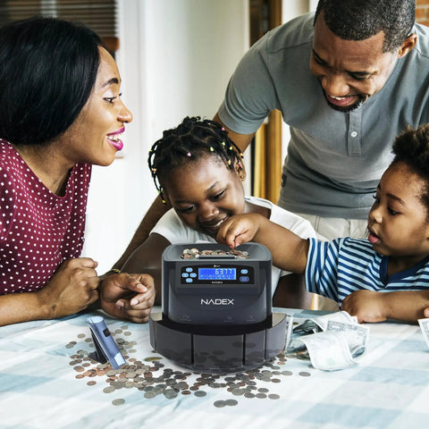 Family using Efficient Coin Counter Sorter And Wrapper Machine with 48 preformed gray wrappers on table.