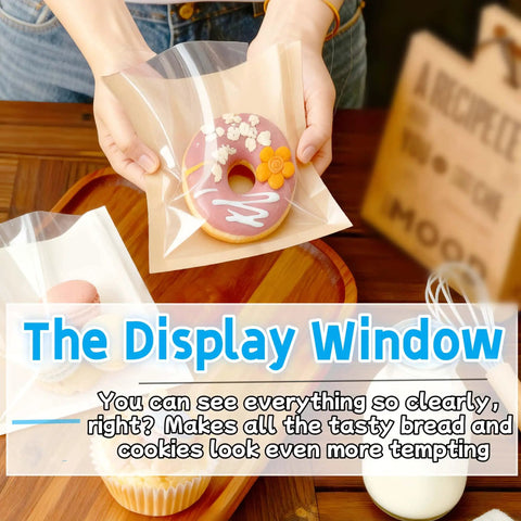 Person holding a 100 Pack 7.1 By 7.5 Inch Cookie Bags With Clear Window Sealing Stickers For Easy Packaging Grease Resistant Brown Paper Bakery Bags For Cookies Bread And Pastries showcasing a donut.
