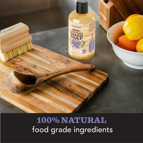 All-In-One Cutting Board Care Kit With Mineral Oil And Finishing Wax Includes Applicator Scrub Brush Buffing Pad And Lavender Rosemary Infused Wood Wax For Long Lasting Board Protection And Conditioning, shown with cutting board, scrub brush, and cutting board soap bottle.