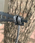 Daisy Chain Climbing Aider For Hunting attached to a tree, showing hand-braided rope on metal stand for tree stand climb aid.