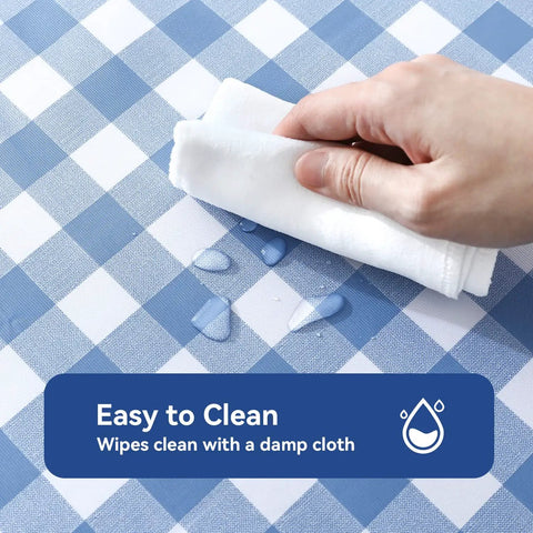 Buffalo Gingham Waterproof Vinyl Tablecloth Heavy Duty Wipeable Checkered Table Cover Outdoor Patio Picnic Camping 54 X 78 Inches Light Blue Spillproof PVC Protector being wiped clean with a cloth