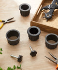 Six Piece Patio Umbrella Base Ring Cover And Cap Kit With M8 Thread Hand Knob Caps Replacement Parts For Patio Umbrella Stands Black Plastic Knobs And Ring Covers 1.95 Inch And 1.55 Inch Sizes on a wooden table