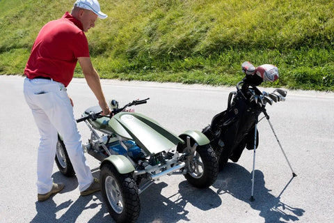 A person adjusting the Smooth Operator Electric Single Rider Golf Cart With Foldable Four Wheel Chassis next to golf clubs.
