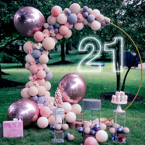 Twenty One Neon Sign LED Wall Light amongst balloons and decorations at outdoor party