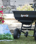 Pro Push Broadcast Spreader 85 Lb Capacity With Durable Plastic Hopper, Corrosion-Resistant And Made In USA beside grass seed bags
