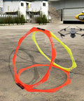 Octagon RC FPV Racing Training Set With PVC Drone Obstacle Course showing orange and yellow rings outdoors