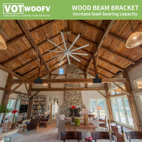 Indoor view highlighting wood beam bracket in cozy cabin with exposed wooden ceilings and large fan.