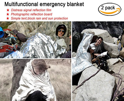 Emergency blanket 2-pack in silver Mylar; hikers wrapped for warmth on rocky terrain.