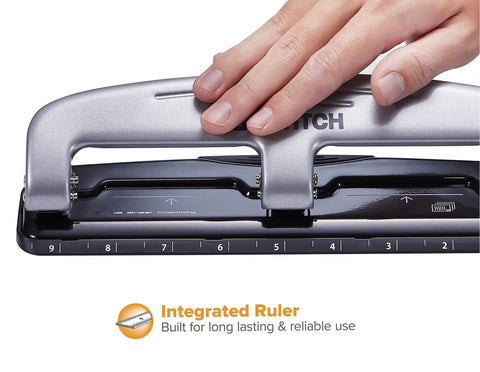 Hand using EZ Squeeze Three Hole Punch For 12 Sheets No Jam 50 Percent Less Force Heavy Duty Metal Construction With Built In Ruler