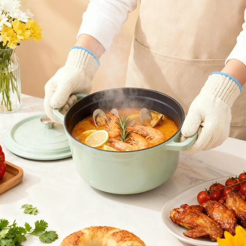 Person using 932F Heat Resistant Oven And Grill Gloves for BBQ Grilling Baking and Welding, holding a green pot with seafood stew.