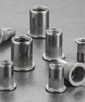 M6 Stainless Steel 304 Rivet Nuts Flat Head Rivnut Threaded Inserts Knurled Body, 200 Pcs, shown on metal surface