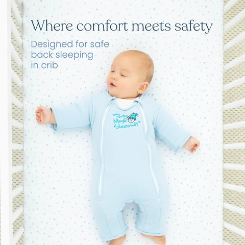 Baby in blue sleep suit designed for back sleeping in a crib with text 'Where comfort meets safety'