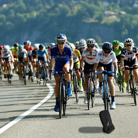Cyclists racing on road with pack of Road And Gravel Bike Inner Tubes 700C 18 To 25 Size With 48mm Presta Valve visible on ground