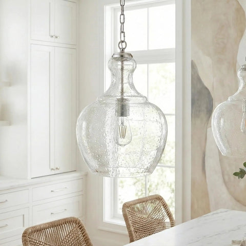 11 Inch Wide Pendant Light With Seeded Glass Shade In Brushed Nickel Finish That Looks Dope Over Your Kitchen Island Or Living Room Flush Mount Ceiling Fixture For Modern Homes hanging in a white kitchen setting.