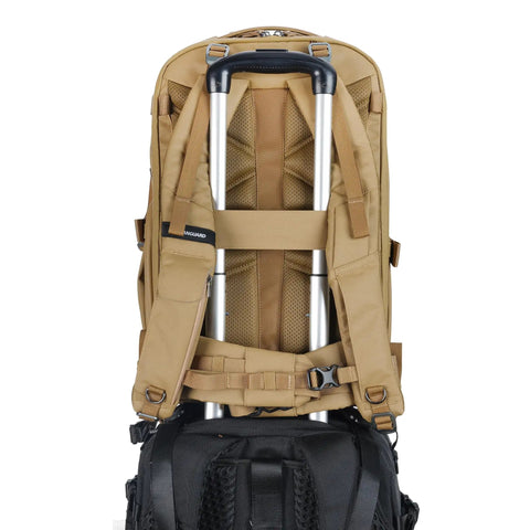 Back view of Metro B30L 30L Camera Backpack With Convertible Daypack in beige, showing straps over suitcase handle, travel-ready design.
