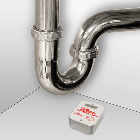 Compact Water Alarm With 360 Degree Sensing And 110 dB Siren next to a pipe, demonstrating water leak detection near plumbing