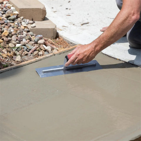 Using QLT Concrete Finishing Trowel With Soft Grip Handle For A Smooth Cement Finish on wet cement, 14 by 4 inch carbon steel blade