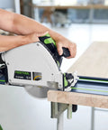 Person using a 100 Year Limited Edition Guide Rail 55 Inch Track Saw Rail For TSC 55 TS 55 TS 75 Splinter Free Edge Guard Anti Slip Surface And Pro Grade Beefy Precision Alignment For Smooth Fast Cuts On Long Projects on a wooden board