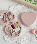 Compact Travel Sewing Kit Two Pack Featuring Adorable Heart Shaped Cases Pink And Blue with sewing essentials inside open pink heart case.